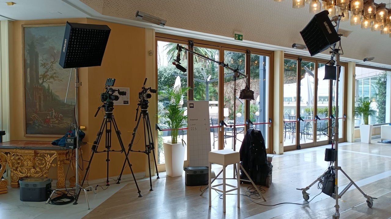 Two-camera interview position in a hotel lobby during a corporate convention in Rome, cinematography by Matteo Castelli